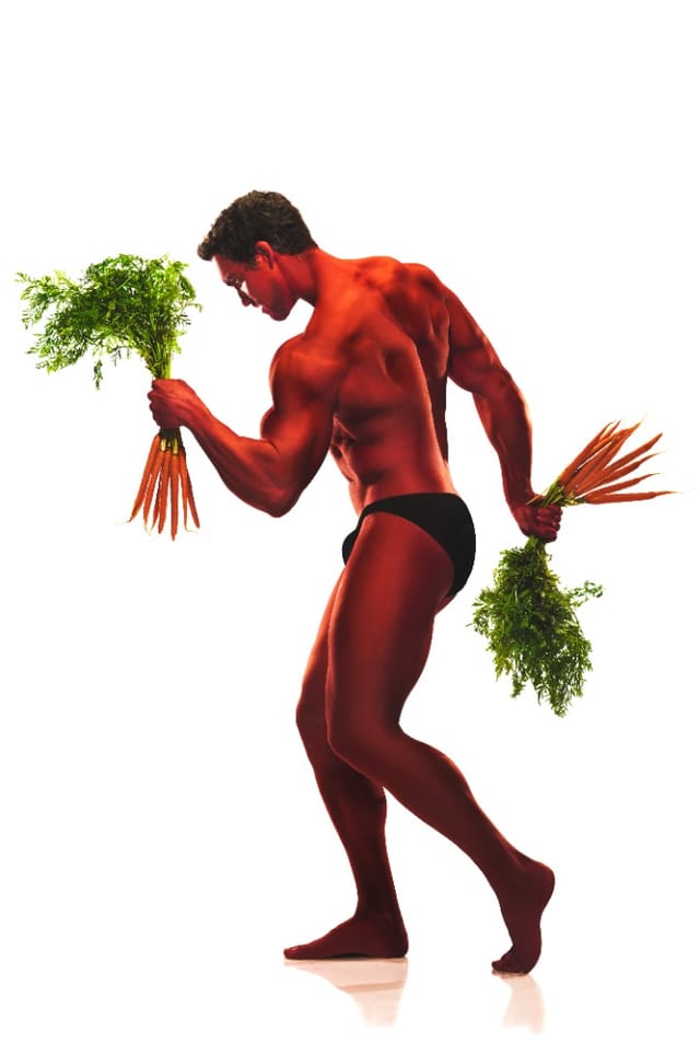 Derek Tresize holding bunches of carrots